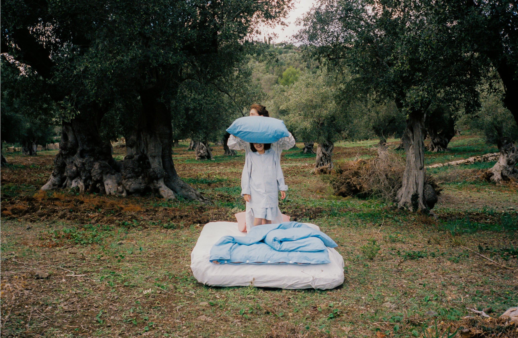 A visual story by artist Agathe Berjaut for Kollekted by x Tekla. Sleepwear, duvet and bedding captured in Olive Fields, Sòller, Mallorca